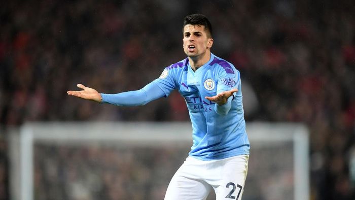 Joao Cancelo MANCHESTER, ENGLAND - MARCH 08: Joao Cancelo of Manchester City reacts during the Premier League match between Manchester United and Manchester City at Old Trafford on March 08, 2020 in Manchester, United Kingdom. (Photo by Michael Regan/Getty Images)