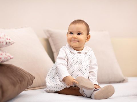 baby girl on the bed among pillows
