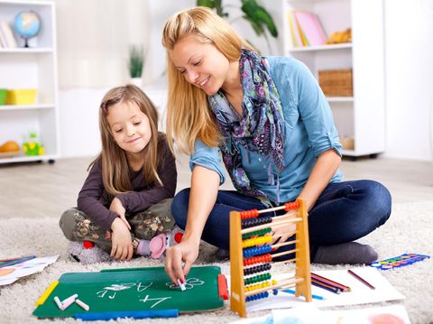 Portrait of a cute little boy playing with his building blocks and toys in his room