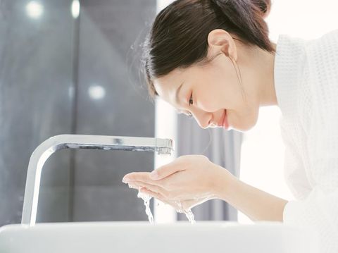 Young Asian Woman Washing Her Face