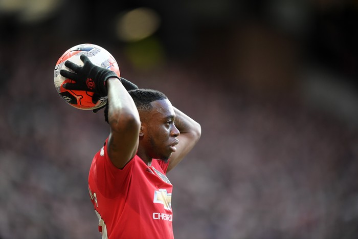 MANCHESTER, ENGLAND - MARCH 08: Aaron Wan-Bissaka of Manchester United throws the ball in during the Premier League match between Manchester United and Manchester City at Old Trafford on March 08, 2020 in Manchester, United Kingdom. (Photo by Michael Regan/Getty Images)