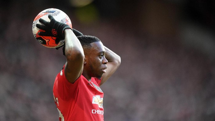 MANCHESTER, ENGLAND - MARCH 08: Aaron Wan-Bissaka of Manchester United throws the ball in during the Premier League match between Manchester United and Manchester City at Old Trafford on March 08, 2020 in Manchester, United Kingdom. (Photo by Michael Regan/Getty Images)