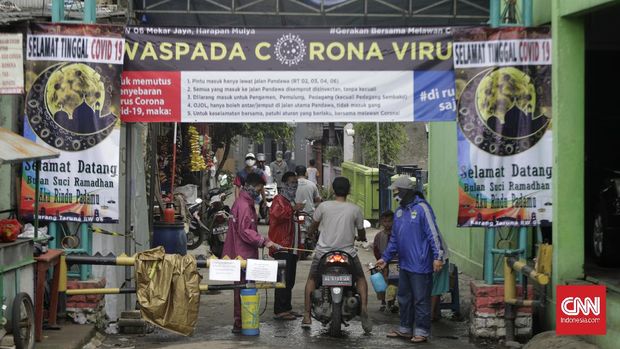 Sejumlah warga melakukan pengawasan mandiri pintu masuk wilayahnya pada hari pertama PSBB. Medan Satria, Bekasi, Jawa Barat, 15 April 2020. CNN Indonesia/Adhi Wicaksono