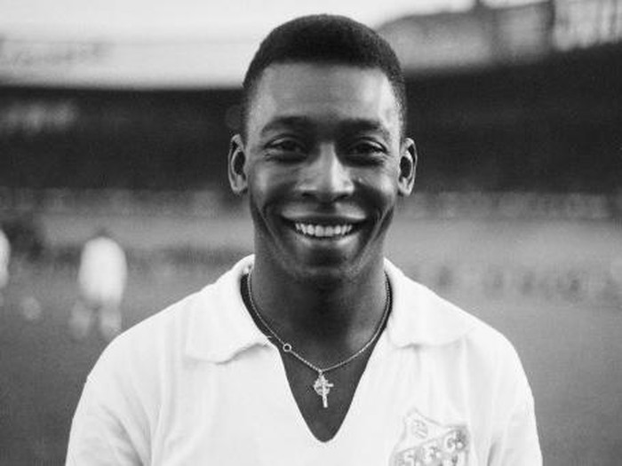 Brazilian striker Pel, wearing his Santos jersey, smiles before playing a friendly soccer match with his club against the French club of 