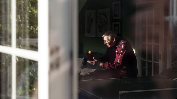 Long-time table tennis player Norrie Short, 85, practices serving while playing table tennis in his lounge at home in Hartley Wintney, a village 45 miles southwest of London on April 3, 2020 during the nationwide lockdown due to the Coronavirus pandemic. - Norrie has been playing in the Aldershot and District Table tennis League since 1952 and coaching for the last 10 years.†Norrie says he obviously had no natural talent for the game as he started in Div. 4 and still plays in Div. 4.†