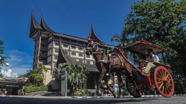 Kuda bendi melintas di depan sebuah hotel yang sepi, di Padang, Sumatera Barat, Rabu (8/4/2020). Data Perhimpunan Hotel dan Restoran (PHRI) Sumbar, sebanyak 26 hotel di provinsi itu tutup sementara akibat pandemi Corona Virus Disease (COVID-19). ANTARA FOTO/Iggoy el Fitra/foc.