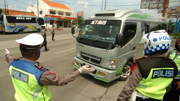 PENYEKATAN PEMUDIK DI JALUR PANTURA Petugas kepolisian memerintahkan mobil travel untuk memutar kembali ke arah Jakarta saat penyekatan di jalur Pantura, Tegal, Jawa Tengah, Senin (27/4/2020). Penyekatan kendaraan pemudik oleh Polres Tegal Kota itu dilakukan menyusul adanya larangan mudik oleh Pemerintah guna mencegah penyebaran COVID-19. ANTARA FOTO/Oky Lukmansyah/hp.