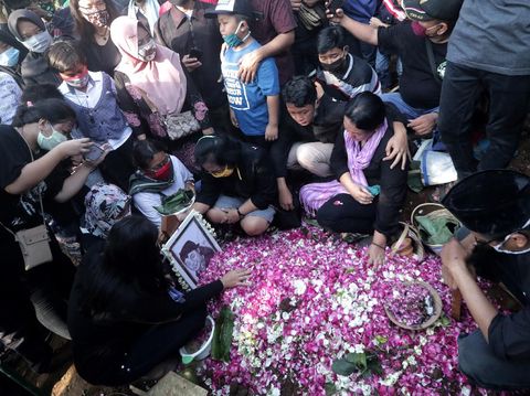 Kerabat menabur bunga di atas pusara almarhum penyanyi campursari Dionisius Prasetyo atau Didi Kempot sesuasi dimakamkan di Tempat Pemakaman Umum Desa Majasem, Ngawi, Jawa Timur, Selasa (5/5/2020). Didi Kempot meninggal di Solo, Jawa Tengah pada usia 53 tahun. ANTARA FOTO/Joni Pratama/zk/hp.