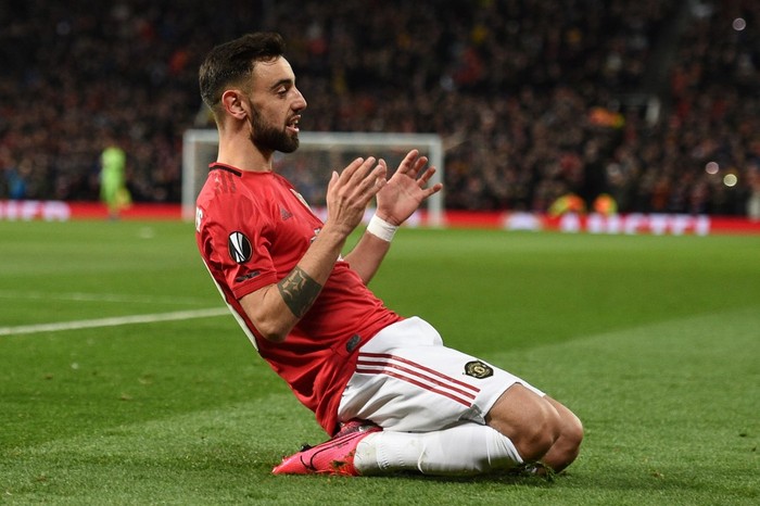 Manchester Uniteds Portuguese midfielder Bruno Fernandes celebrates scoring his teams first goal during the UEFA Europa League round of 32 second leg football match between Manchester United and Club Brugge at Old Trafford in Manchester, north west England, on February 27, 2020. (Photo by Oli SCARFF / AFP)