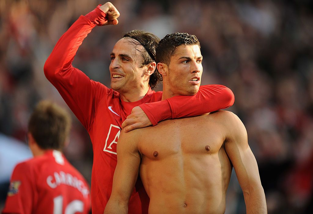 MANCHESTER, ENGLAND - APRIL 25:  Cristiano Ronaldo (R) of Manchester United is congratulated by team mate Dimitar Berbatov after scoring his team's third goal during the Barclays Premier League match between Manchester United and Tottenham Hotspur at Old Trafford on April 25, 2009 in Manchester, England.  (Photo by Shaun Botterill/Getty Images)
