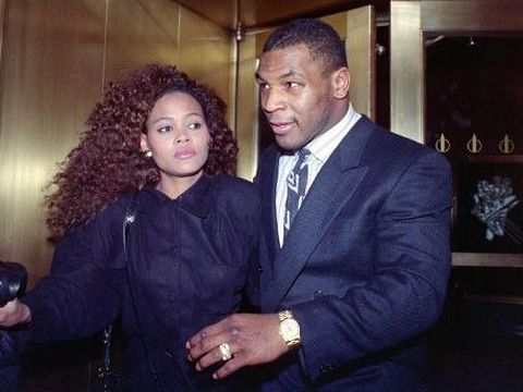 US heavyweight champion Mike Tyson exits the Nippon Television Network International studio in New York with his new bride actress Robin Givens, 09 February 1988. Tyson attended the live satellite press conference between New York and Japan from the studio to promote his, 21 March 1988, title bout with Tony Tubbs to be held in Japan's Tokyo Dome. (Photo by MARIA BASTONE / AFP)