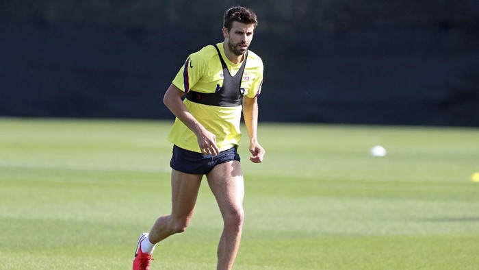 In this photo provided by FC Barcelona, Barcelonas Gerard Pique runs with the ball during a training session in Barcelona, Spain on Friday May 8, 2020. Soccer players in Spain returned to train for the first time since the country entered a lockdown nearly two months ago because of the coronavirus pandemic. (Miguel Ruiz/FC Barcelona via AP)
