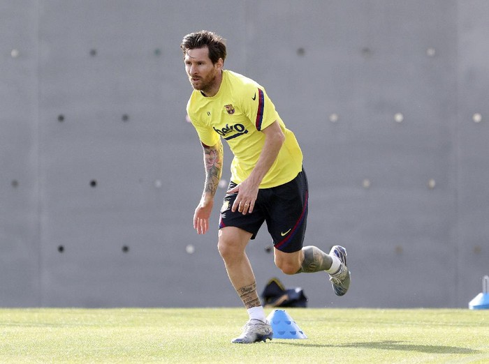 In this photo provided by FC Barcelona, Lionel Messi trains in Barcelona, Spain, on Friday May 8, 2020. Soccer players in Spain returned to train for the first time since the country entered a lockdown nearly two months ago because of the coronavirus pandemic. (Miguel Ruiz/FC Barcelona via AP)