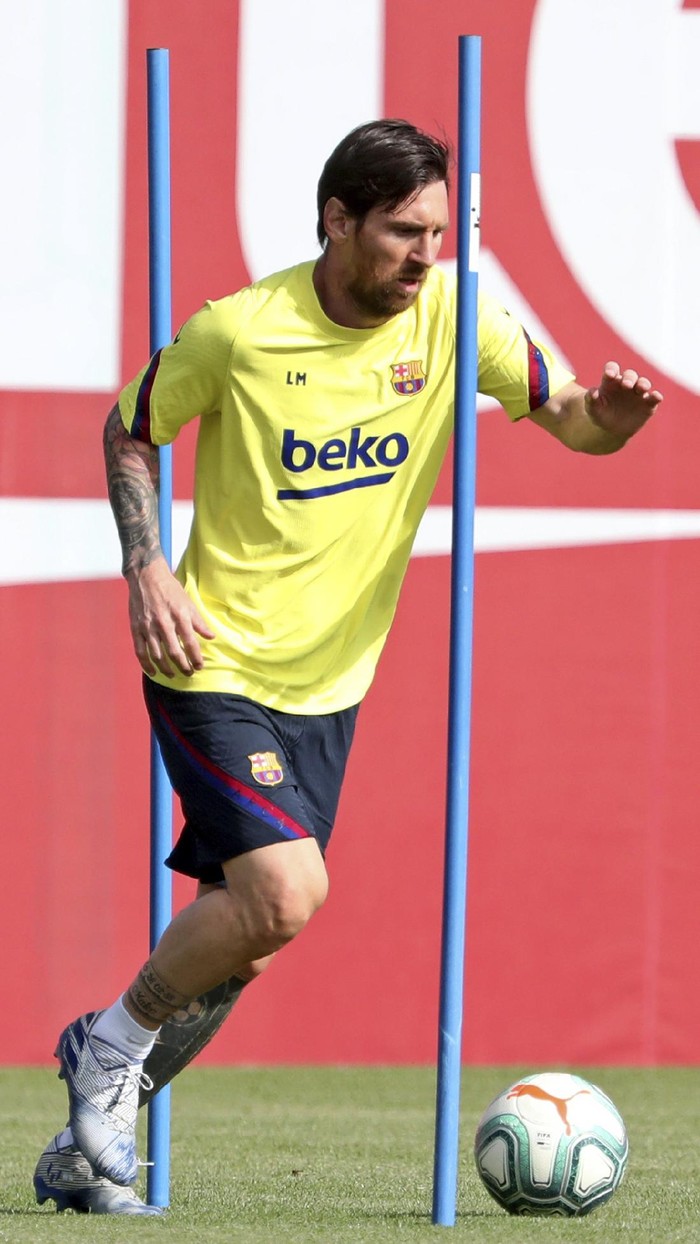 In this photo provided by FC Barcelona, Barcelona's Lionel Messi trains in Barcelona, Spain, on Friday May 8, 2020. Soccer players in Spain returned to train for the first time since the country entered a lockdown nearly two months ago because of the coronavirus pandemic. (Miguel Ruiz/FC Barcelona via AP)