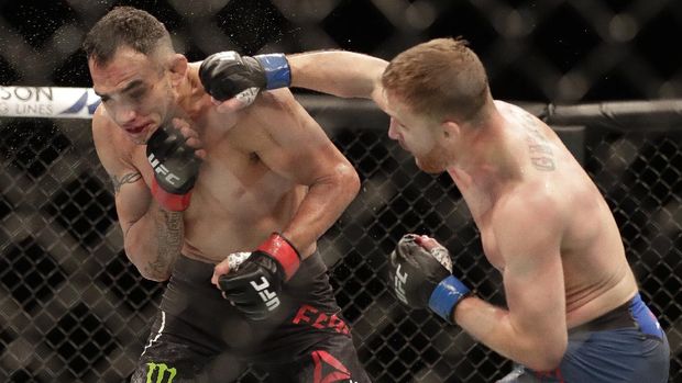 Justin Gaethje, right, punches Tony Ferguson during a UFC 249 mixed martial arts bout, Saturday, May 9, 2020, in Jacksonville, Fla. (AP Photo/John Raoux)