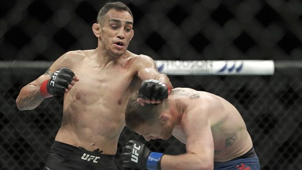 Justin Gaethje, right, ducks from a punch by Tony Ferguson, left, during a UFC 249 mixed martial arts bout, Saturday, May 9, 2020, in Jacksonville, Fla. (AP Photo/John Raoux)