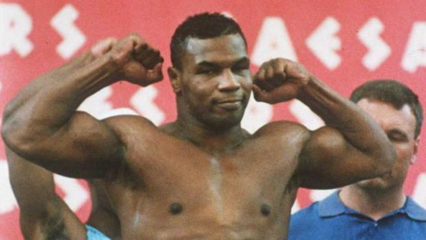 Mike Tyson, who is scheduled to be released from prison 25 March, strikes a pose 15 June 1990 during the weigh-in for his first heavyweight fight after losing the title to James 