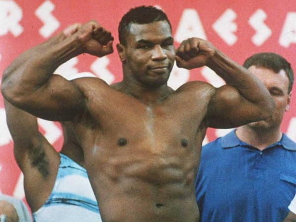 Mike Tyson, who is scheduled to be released from prison 25 March, strikes a pose 15 June 1990 during the weigh-in for his first heavyweight fight after losing the title to James 