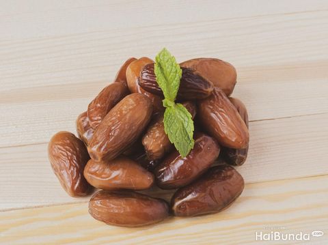 juicy Dried date fruits or kurma, ramadan meal with mint leaf, flat lay