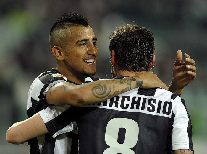 TURIN, ITALY - APRIL 21:  Arturo Vidal (L) of Juventus celebrates with team-mate Claudio Marchisio after scoring their teams first goal from a penalty during the Serie A match Juventus FC v AC Milan at Juventus Arena on April 21, 2013 in Turin, Italy.  (Photo by Claudio Villa/Getty Images)