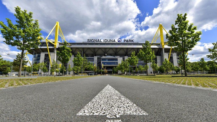 A directional arrow on a street points to the Signal Iduna Park, Germanys biggest stadium of Borussia Dortmund in Dortmund, Germany, Thursday, May 14, 2020. Bundesliga will now restart on May 16, 2020 when Borussia Dortmund will play the derby against FC Schalke 04 at home without spectators due to the coronavirus outbreak. (AP Photo/Martin Meissner)