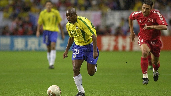 SAITAMA - JUNE 26:  Edilson of Brazil is chased by Fatih Akyel of Turkey during the Brazil v Turkey, World Cup Semifinal Stage match played at the Saitama Stadium, Saitama in Japan on June 26, 2002. Brazil won 1-0. (Photo by Stu Forster/Getty Images)