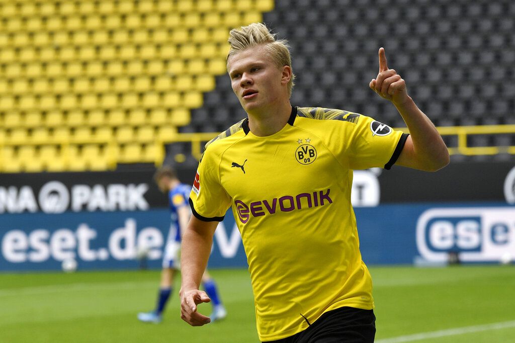 Dortmund's Erling Haaland celebrates after scoring the opening goal during the German Bundesliga soccer match between Borussia Dortmund and Schalke 04 in Dortmund, Germany, Saturday, May 16, 2020. The German Bundesliga becomes the world's first major soccer league to resume after a two-month suspension because of the coronavirus pandemic. (AP Photo/Martin Meissner, Pool)