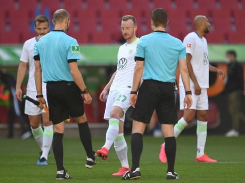 Maximilian Arnold dari Wolfsburg melakukan tos kaki dengan wasit seusai laga melawan Augsburg.