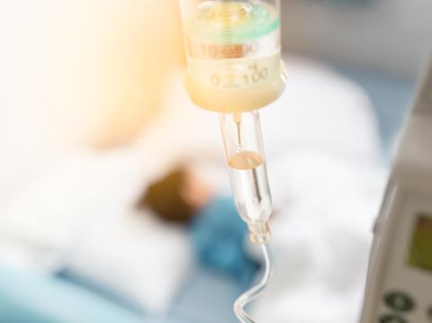 Sick child sleep on the bed in hospital during have a saline drip