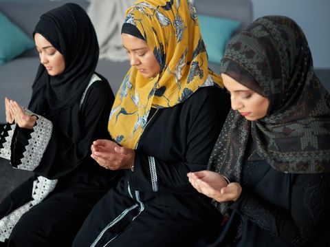 Shot of a group of young muslim women praying together indoors