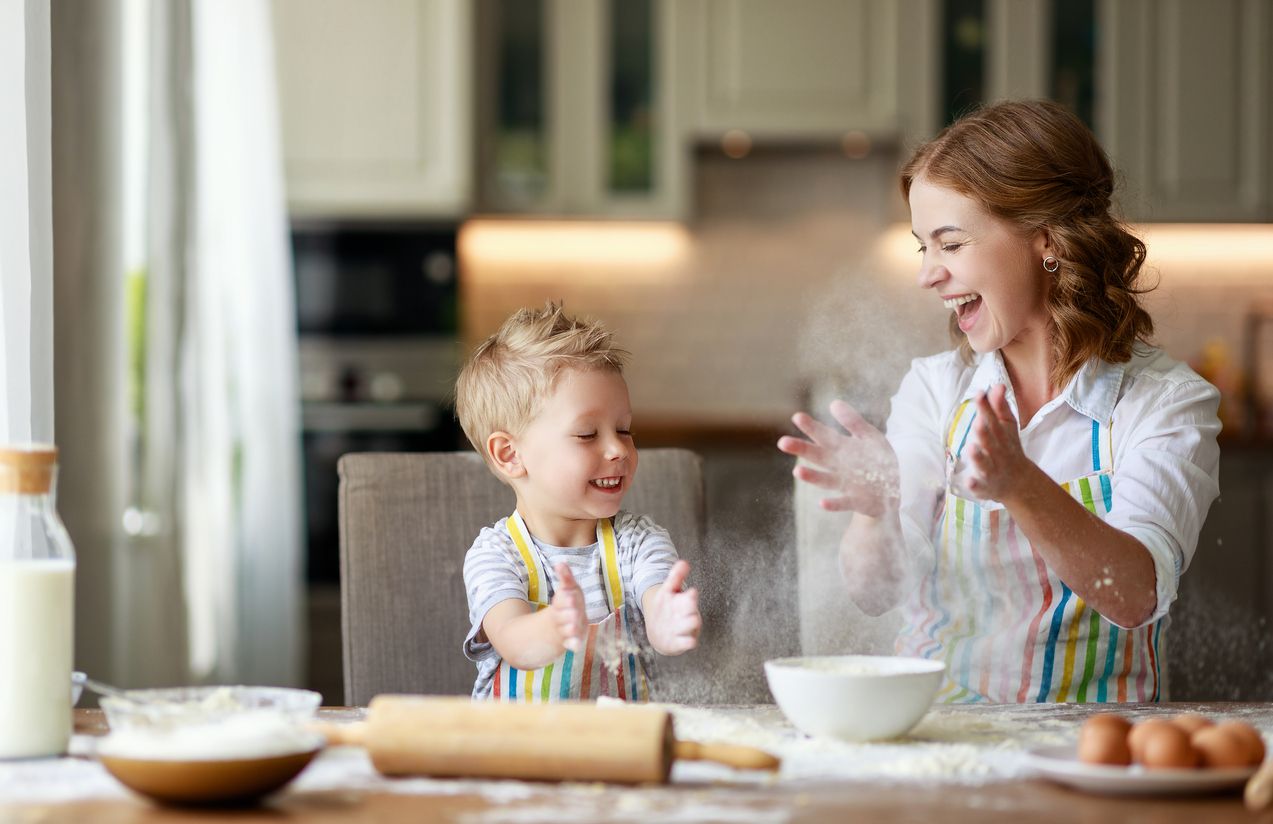 happy family in the kitchen. mother and  child son preparing the dough, bake cookies