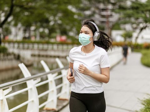 a asian woman doing a exercise in a park of Jakarta City, Indonesia, during quarantine cause corona pandemic