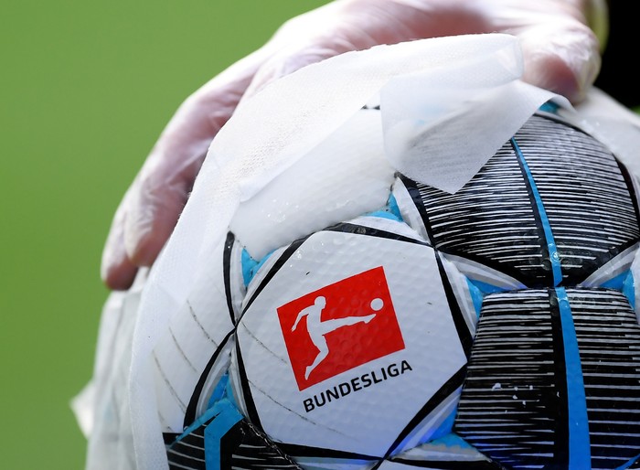 BREMEN, GERMANY - MAY 18: An employee of Werder Bremen disinfects an official match ball ahead of the Bundesliga match between SV Werder Bremen and Bayer 04 Leverkusen at Wohninvest Weserstadion on May 18, 2020 in Bremen, Germany. The Bundesliga and Second Bundesliga is the first professional league to resume the season after the nationwide lockdown due to the ongoing Coronavirus (COVID-19) pandemic. All matches until the end of the season will be played behind closed doors. (Photo by Stuart Franklin/Getty Images)