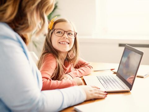 Mother and daughter Having fun with laptop at home