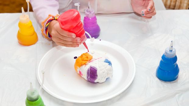 Little girl making a tie dye shirt