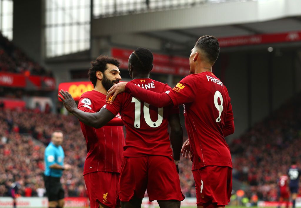 LIVERPOOL, ENGLAND - MARCH 07: Sadio Mane of Liverpool celebrates with Mohamed Salah and Roberto Firmino after scoring his team's second goal during the Premier League match between Liverpool FC and AFC Bournemouth  at Anfield on March 07, 2020 in Liverpool, United Kingdom. (Photo by Jan Kruger/Getty Images)