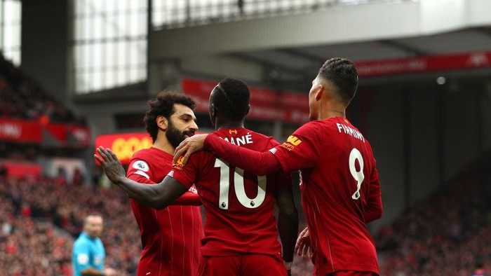 LIVERPOOL, ENGLAND - MARCH 07: Sadio Mane of Liverpool celebrates with Mohamed Salah and Roberto Firmino after scoring his teams second goal during the Premier League match between Liverpool FC and AFC Bournemouth  at Anfield on March 07, 2020 in Liverpool, United Kingdom. (Photo by Jan Kruger/Getty Images)