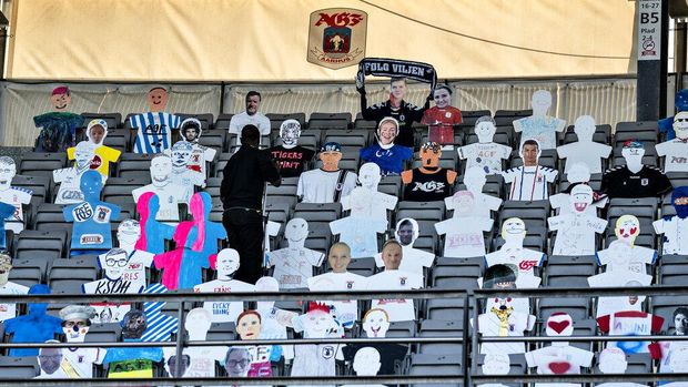 People watch the Danish Super League soccer match between AGF and Randers FC  via videolink, at Ceres Park in Aarhus, Denmark, Thursday, May 28, 2020. The match is the first to be played after the shutdown due to the outbreak of the coronavirus and is being played without spectators and with restrictions. (Henning Bagger/Ritzau Scanpix via AP)