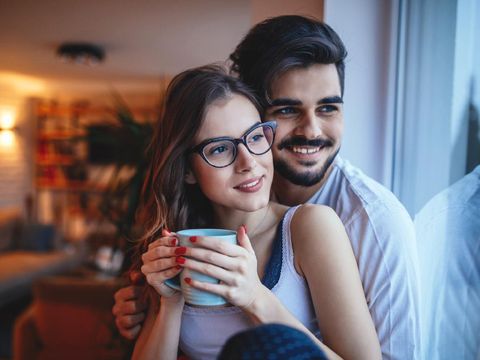 Portrait of a happy young couple cuddling at home.