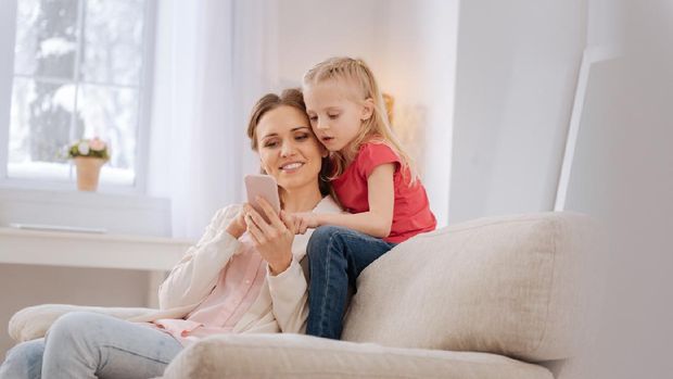 Orang tua menggunakan ponsel atau gadget depan anak