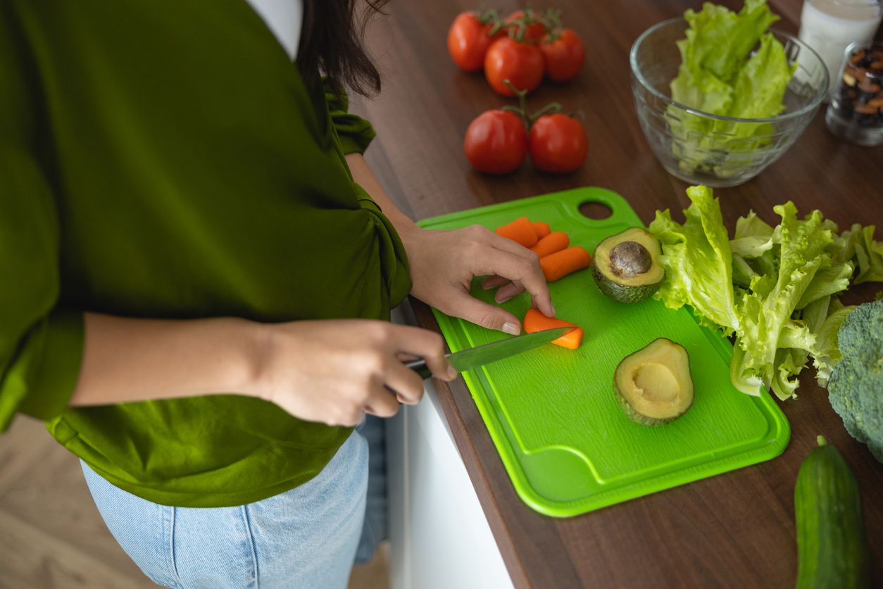 Cropped photo of a female cook preparing soup ingredients