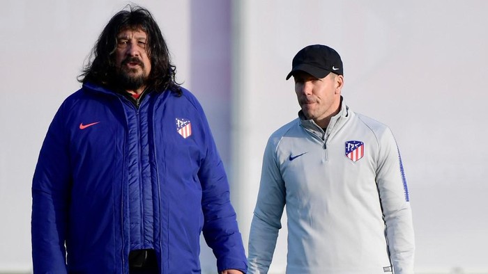 (FILES) In this file photo taken on February 19, 2019 Atletico Madrids Argentinian coach Diego Simeone (R) and Argentinian assistant coach German 