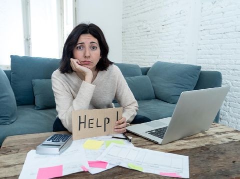 Portrait of worried young woman feeling stressed and desperate asking for help in paying bills, debts, tax expenses and accounting home finances with laptop. In online banking and financial problems.