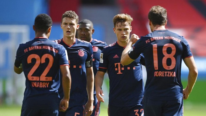 Serge Gnabry of Munich celebrates his teams third goal with teammates Benjamin Pavard, Joshua Kimmich and Leon Goretzka during the German Bundesliga soccer match between Bayer Leverkusen and Bayern Munich in Leverkusen, Germany, Saturday, June 6, 2020. (Matthias Hangst, Pool via AP)