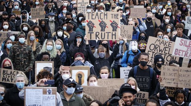 People take part in a Black Lives Matter protest rally in Piccadilly Gardens, Manchester, England, Saturday, June 6, 2020, after the recent killing of George Floyd by police officers in Minneapolis, USA, that has led to protests in many countries and across the US. (Danny Lawson/PA via AP)
