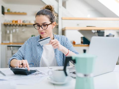 Young woman paying bills/ shopping online with credit card