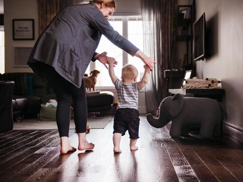 Son practice his first step with his mom. Horizontal and color photo was taken in Quebec Canada.