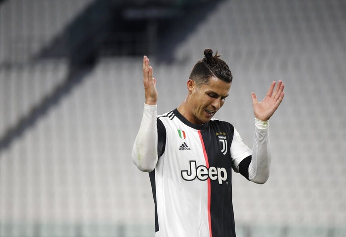 Juventus Cristiano Ronaldo reacts during an Italian Cup second leg soccer match between Juventus and AC Milan at the Allianz stadium, in Turin, Italy, Friday, June 12, 2020. The match was being played without spectators because of the coronavirus lockdown. (AP Photo/Luca Bruno)