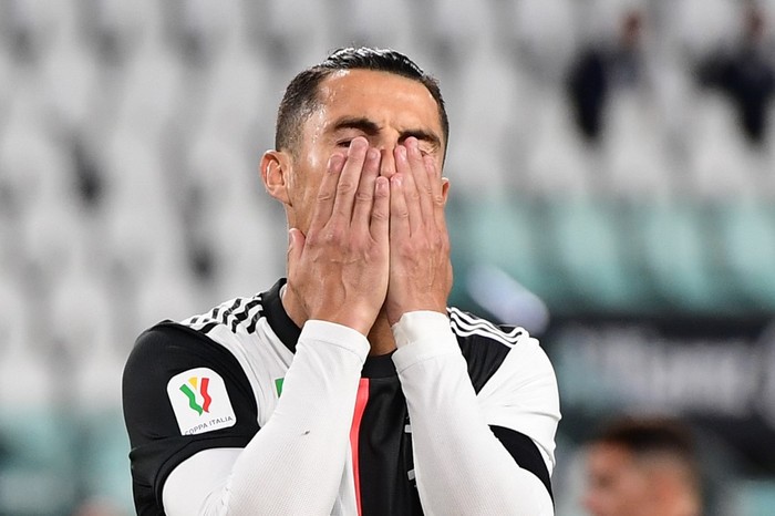 Juventus Portuguese forward Cristiano Ronaldo reacts after missing a penalty during the Italian Cup (Coppa Italia) semi-final second leg football match Juventus vs AC Milan on June 12, 2020 at the Allianz stadium in Turin, the first to be played in Italy since March 9 and the lockdown aimed at curbing the spread of the COVID-19 infection, caused by the novel coronavirus. (Photo by Miguel MEDINA / AFP)