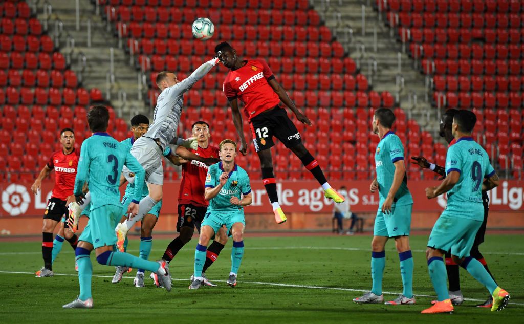 MALLORCA, SPAIN - JUNE 13: Iddrisu Babav of RCD Mallorca battles for possession with Marc-Andre ter Stegen of FC Barcelona during the La Liga match between RCD Mallorca and FC Barcelona at Estadio de Son Moix on June 13, 2020 in Mallorca, Spain. (Photo by David Ramos/Getty Images)
